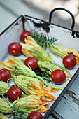 Stuffed courgette flowers with cherry tomatoes and rosemary