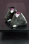 Onigiri in nori leaves filled with red shiso leaves and tuna (Japan)