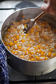 Pumpkin risotto with orange being made