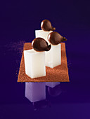 Solid and liquid cocoa on milk cubes (molecular gastronomy)
