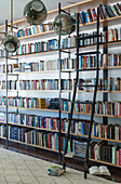 Ceiling-high bookshelves with sliding shelf ladder