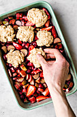 Making a vegan cobbler with rhubarb and berries