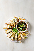 Fried asian dumplings Gyozas potstickers in white ceramic plate served with bowl of soy onion sauce