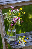 Vase of summer wildflowers with red campion, buttercups, ground elder and ox-eye daisies