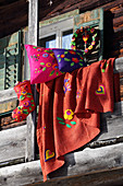 Wreath, cushions, blanket and Christmas stocking decorated with ethnic felt motifs