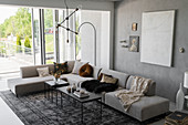 Corner sofa and floor-to-ceiling terrace doors in grey living room