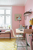 Desk in feminine room with pink walls and yellow carpet