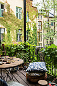 Balcony of Bohemian-style period apartment with plants growing on railing