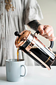 Pouring a cup of coffee from a French press
