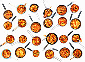 A collage of pasta pans with tomatoes