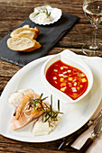 Bouillabaisse and salmon, served with king prawns and cod with rosemary