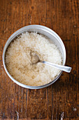 Grated parmesan in a bowl with a spoon