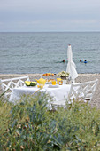 A table laid for breakfast on a beach