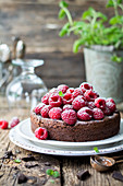 Chocolate cake with raspberries and powdered sugar