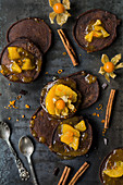 Chocolate pancakes with oranges, cinnamon and physalis