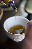 Pouring olive oil into a bowl