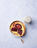 Plum Clafoutis Individual with powdered sugar and fork