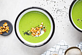 Pea soup with nut topping, sesame and yoghurt