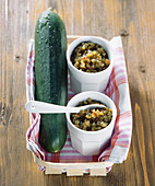 Two cups of cucumber relish in a basket
