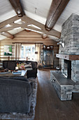 Open fireplace and exposed ceiling beams in rustic living room