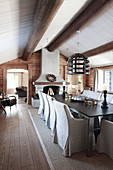 Open fireplace and exposed ceiling beams in rustic dining room