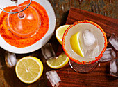Pisco sour cocktail with lemon in a glass with a sugared rim