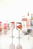 Pink gin cocktails in a variety of glassware