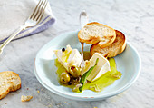 Pickled creamy Camembert with olives, onion and sage served with grilled baguette