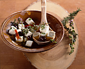 Greek sheep's cheese pickled in olive oil with garlic, thyme, rosemary, herbs, chilli and olives