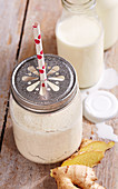 A banana and ginger lassi in a screw-top jar with yoghurt, lime and spices