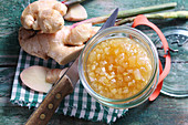 A jar of pear jam with fresh ginger