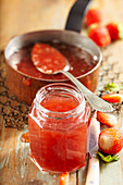 Summer strawberry and melon jam in an antique copper pot