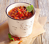 Spicy pepper relish in a ceramic pot