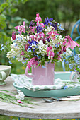 Spring bouquet of lilacs, columbines, bleeding hearts and forget-me-nots