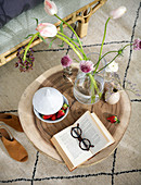 Open book, strawberries and flowers on coffee table