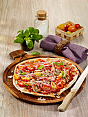 Bread pizza with ham, cherry tomatoes and peppers