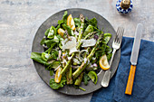A green asparagus salad with tomatoes and Parmesan