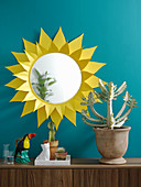 Round mirror with handmade yellow paper sunburst