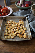 Homemade croutons on a baking tray