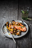 A plate of paella with prawns and mussels