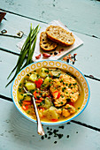 Fish soup with salmon on turquoise background