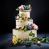 Three-tier wedding cake with chocolate layers, vanilla buttercream, raspberry filling and flower decoration