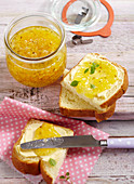 Courgette and pineapple jam in a jar and on a slice of brioche