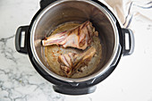 Lamb shanks cooking in pot