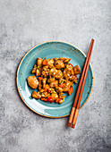 Top view of Kung Pao chicken on a plate ready for eat. Stir-fried Chinese traditional dish