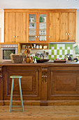Wooden wall units and counter in country-house kitchen