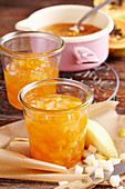 Papaya and pear jam in jars and in a saucepan