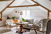 Cosy seating area in converted attic of Swedish house