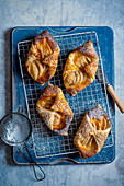 Pear and almond frangipanne puff pastry tartlets with sesame seeds and icing sugar