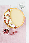 Liquorice tart decorated with liquorice balls and cream drops